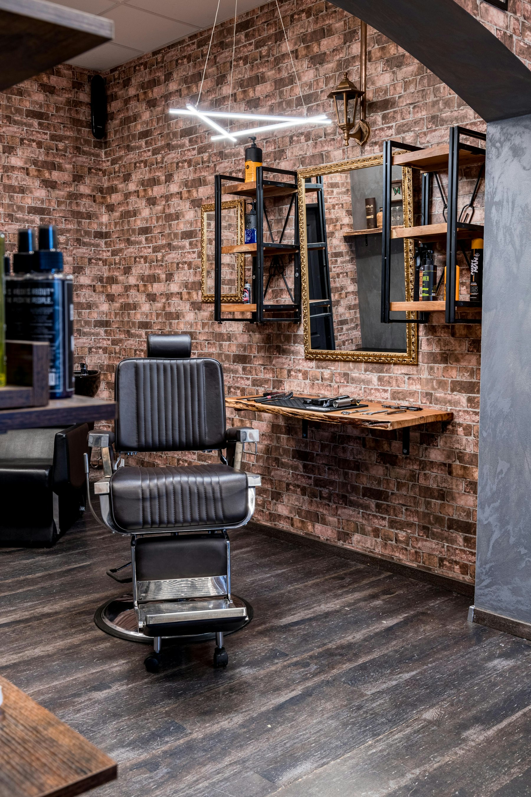Barber chair in front of a brick wall